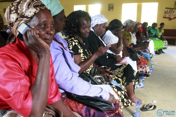 Women in Kitui County attend a community forum session on SMS