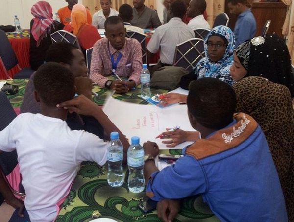 Breakout groups discussing the enabling and hindering forces impacting their work in Zanzibar